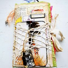 an altered book with laces and pictures on it