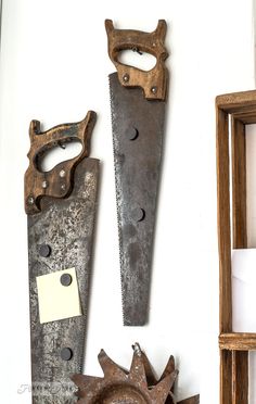 three different types of knives hanging on the wall