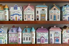 a shelf filled with lots of different colored houses