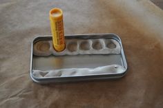 an empty metal tray with a rolling roller on it and a bottle of orange juice in the middle