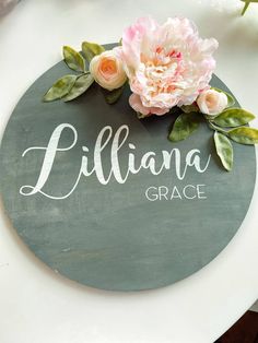 a sign that says lilliana grace with flowers on it