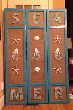 an ocean themed cabinet with sea words and seashells