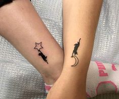 two people holding hands with tattoos on their arms and one has a cat sitting on the moon