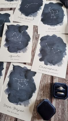 astro cards with ink in them on a wooden table