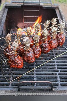 meat on skewers being grilled over an open fire