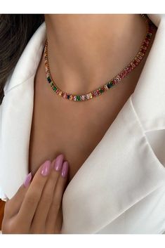 Add a vibrant touch to your jewelry collection with our Rainbow Baguette Tennis Choker Necklace. This exquisite piece features a stunning array of colorful baguette-cut stones set in a sleek gold-plated chain. The combination of the radiant gemstones and the elegant design creates a captivating necklace that is sure to turn heads. Crafted with meticulous attention to detail, this choker necklace offers a perfect balance between sophistication and playfulness. The rainbow-colored stones bring a j Sideways Cross Necklace Silver, Tennis Choker Necklace, Anodized Aluminum Jewelry, Dainty Choker Necklace, Baguette Necklace, Choker Necklace Gold, Gold Chain Choker, Aluminum Jewelry, Colorful Necklace