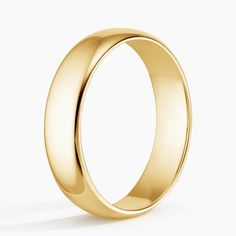 a yellow gold wedding ring on a white background with the top half facing towards the camera