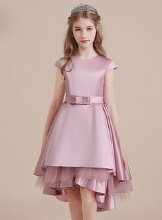 This elaborate gown is based on Victorian fashion and is done primarily in cool colors like the baby pink. It has a flared skirt with a corset about the waist and short wide sleeves.it has a silk belt. It has an A- link silhouette and a Hi-lo hemline. The quality of the material is very strong and beautiful. It has a cap sleeve that gives a beautifully feminine appearance. It has a bow placed at the center, and the fabric used is Satin. It has a wide skirt with an A-line waist and a single round sleeve. Kids Flower Girl Dresses, High Low Party Dresses, Afghani Clothes, Satin Flower Girl Dress, Girls Dresses Online, Baby Frock, White Flower Girl Dresses, Satin Tulle, Flower Girl Dresses Tulle