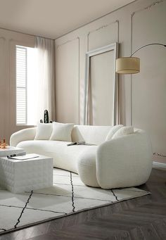 a living room with white furniture in it