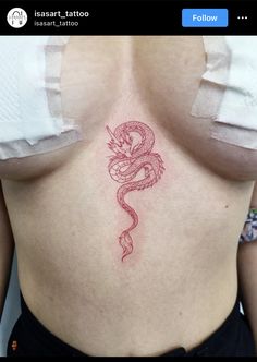 a woman's breast with a red dragon tattoo on her stomach and the other side