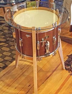 a wooden table with a drum on it