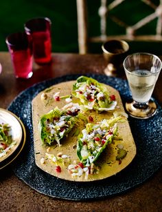 a tortilla with lettuce and other toppings sits on a plate