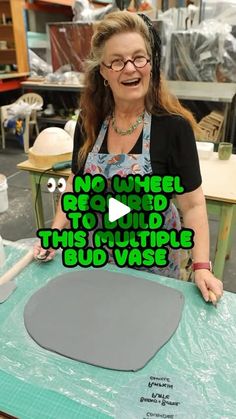 a woman with an apron on is making a round shaped object out of foam and plastic