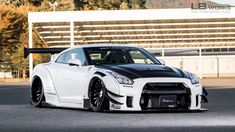 a white sports car parked in front of a building