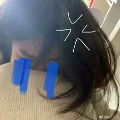 a woman with her head in the back of a car seat and two blue strips sticking out of her hair