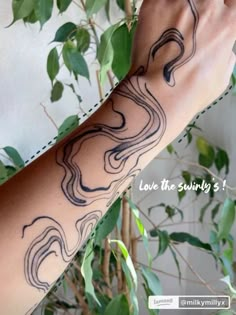 a woman's arm with tattoos on it and the words love the swirly 3