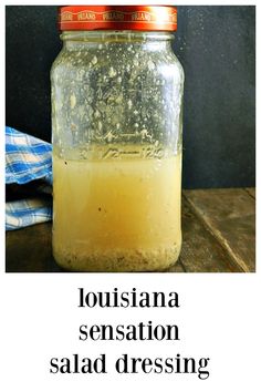 a jar filled with liquid sitting on top of a wooden table