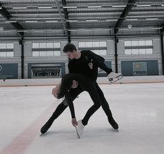 two people skating on an ice rink with one holding the other's leg up