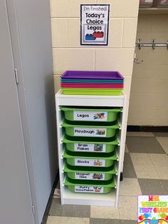 a stack of green and purple bins sitting on top of a checkered floor