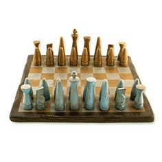 a wooden chess board with blue and white pieces on it's side, including one pawn