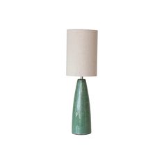 a green table lamp with a white shade on the base and a beige linen lampshade