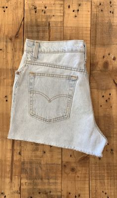 "High waisted 90's denim shorts. Made by Levi's in light blue denim wash. Shorts are in excellent clean condition. Perfectly worn in with light naturally distressed character. These have been cut off and washed once. Measurements are taken zipped or buttoned up and laid comfortably flat then x 2 for total circumference (inches) Levis 551 Tag Size 14 100% Cotton Made in USA Waist 33\" Hips 44\" Length 13.5\" Inseam 2.25\" Rise 12.5\" leg opening circumference 27\" All items are free of rips, tear Vintage Jeans With Built-in Shorts For Spring, 90s Style Light Wash Cutoff Jeans, 90s Light Wash Cutoff Jeans, Retro Light Wash Short Jeans, Retro Light Wash Short Bottoms, 90s Denim Jean Shorts, 90s-style Denim Blue Jean Shorts, 90s Style Denim Blue Shorts, Retro Cutoff Light Wash Jeans