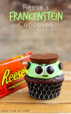 there is a cupcake with googly eyes on it and a box of reese's frankensteinen cupcakes