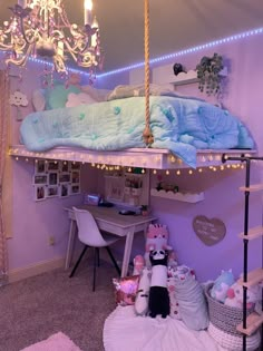 a room with a bed, desk and chair in it that has lights strung from the ceiling