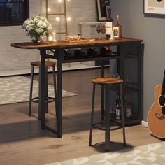 a table with two stools and a guitar