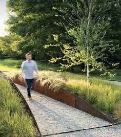 a person walking down a path in the grass