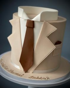 a close up of a cake with a tie on it