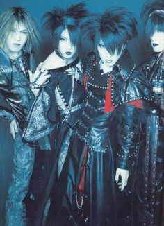 the group of punk rockers is posing for a photo in black leather outfits with spikes on their head