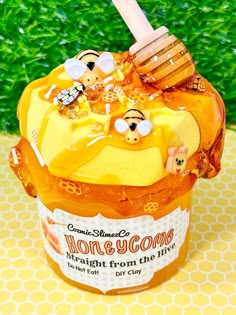 a honey jar filled with lots of honey sitting on top of a table