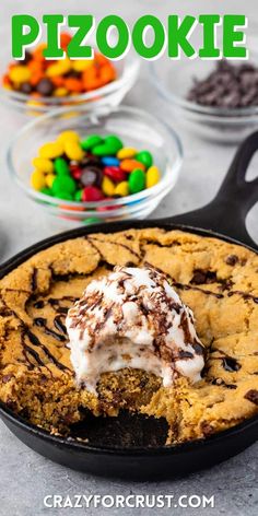 a skillet filled with chocolate chip cookie and marshmallows in the background