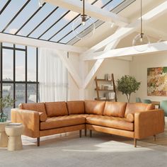 a living room filled with lots of furniture next to a large glass window covered in white curtains