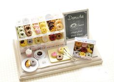 miniature donuts and pastries are displayed on a tray