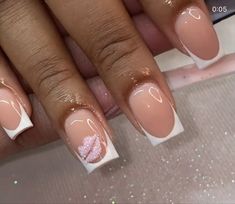 a woman's nails with pink and white designs on them