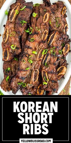 korean short ribs on a white plate with green onions