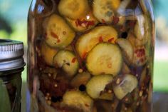 a jar filled with pickles sitting on top of a table