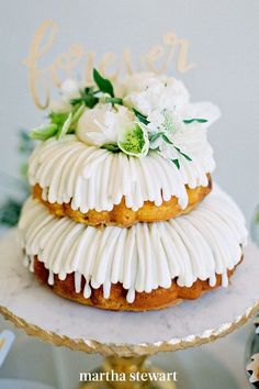 a cake with icing and flowers on top