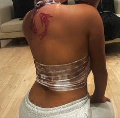 a woman with a tattoo on her back