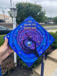 someone is holding up a blue graduation cap that says see you on the other side