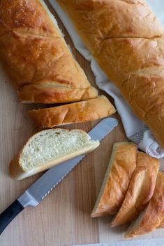 a loaf of bread sitting on top of a cutting board next to a knife