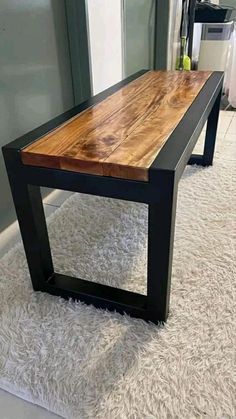 a wooden table sitting on top of a white rug