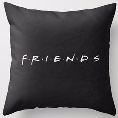 a black pillow with the word friends printed on it