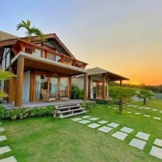 a large house sitting on top of a lush green field