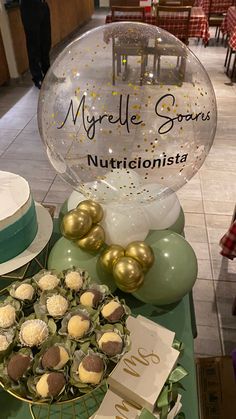 a table topped with lots of desserts and balloons