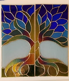 two stained glass panels with a tree on them