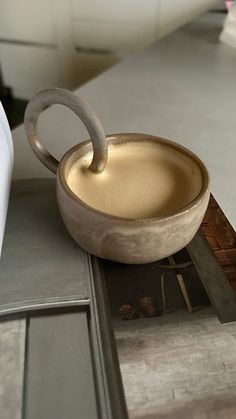 a bowl sitting on top of a counter next to a knife