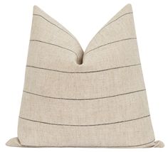 a beige and black striped pillow on a white background